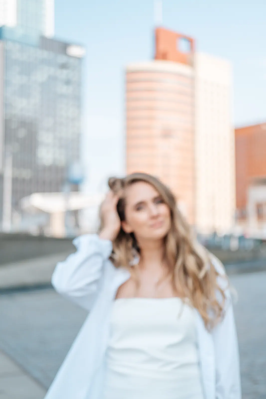 Carlijn Bekker, social media strateeg, in een wit overhemd voor de skyline
